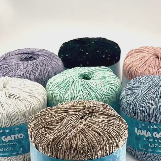Lana Gatto IBIZA lurex cotton paillettes yarn with elegant sparkle
Italian fingering yarn IBIZA with micro sequins and metallic accents
Lana Gatto IBIZA summer yarn showing light-catching shimmer and texture
Lurex cotton paillettes yarn for beachwear summer tops and shawls
Luxury Italian IBIZA yarn for statement accessories and warm-weather knitwear