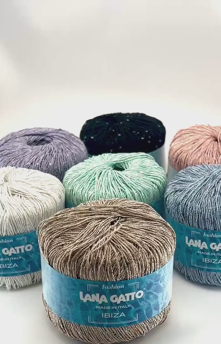 Lana Gatto IBIZA lurex cotton paillettes yarn with elegant sparkle
Italian fingering yarn IBIZA with micro sequins and metallic accents
Lana Gatto IBIZA summer yarn showing light-catching shimmer and texture
Lurex cotton paillettes yarn for beachwear summer tops and shawls
Luxury Italian IBIZA yarn for statement accessories and warm-weather knitwear