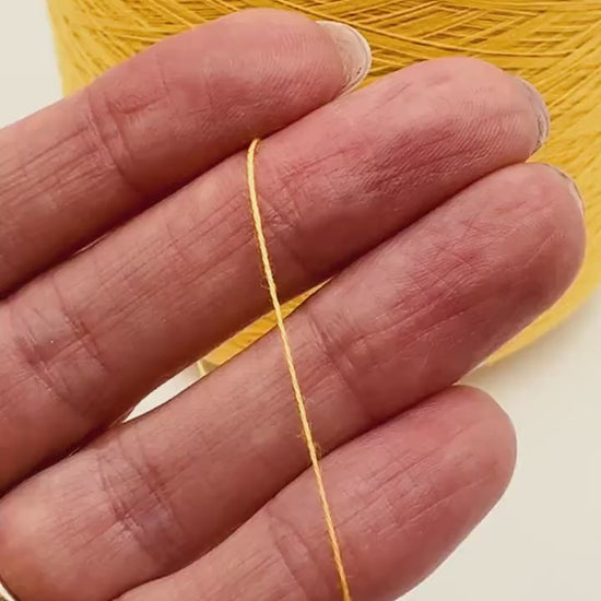 YUMA by Prisma Ricerche — sunflower yellow ecological lace-weight cable cotton yarn, shown on cone and in texture close-ups, available at iDOKNiT.