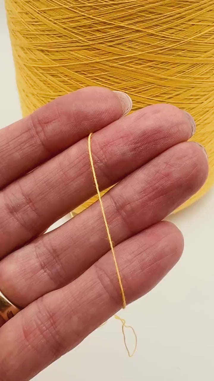 YUMA by Prisma Ricerche — sunflower yellow ecological lace-weight cable cotton yarn, shown on cone and in texture close-ups, available at iDOKNiT.