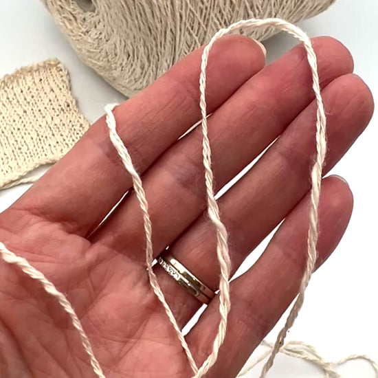 Cone of COTTON FLAME Italian flammé cotton yarn in natural cream color, premium sport weight cotton yarn for sweaters, cardigans, tops, and summer knitwear.