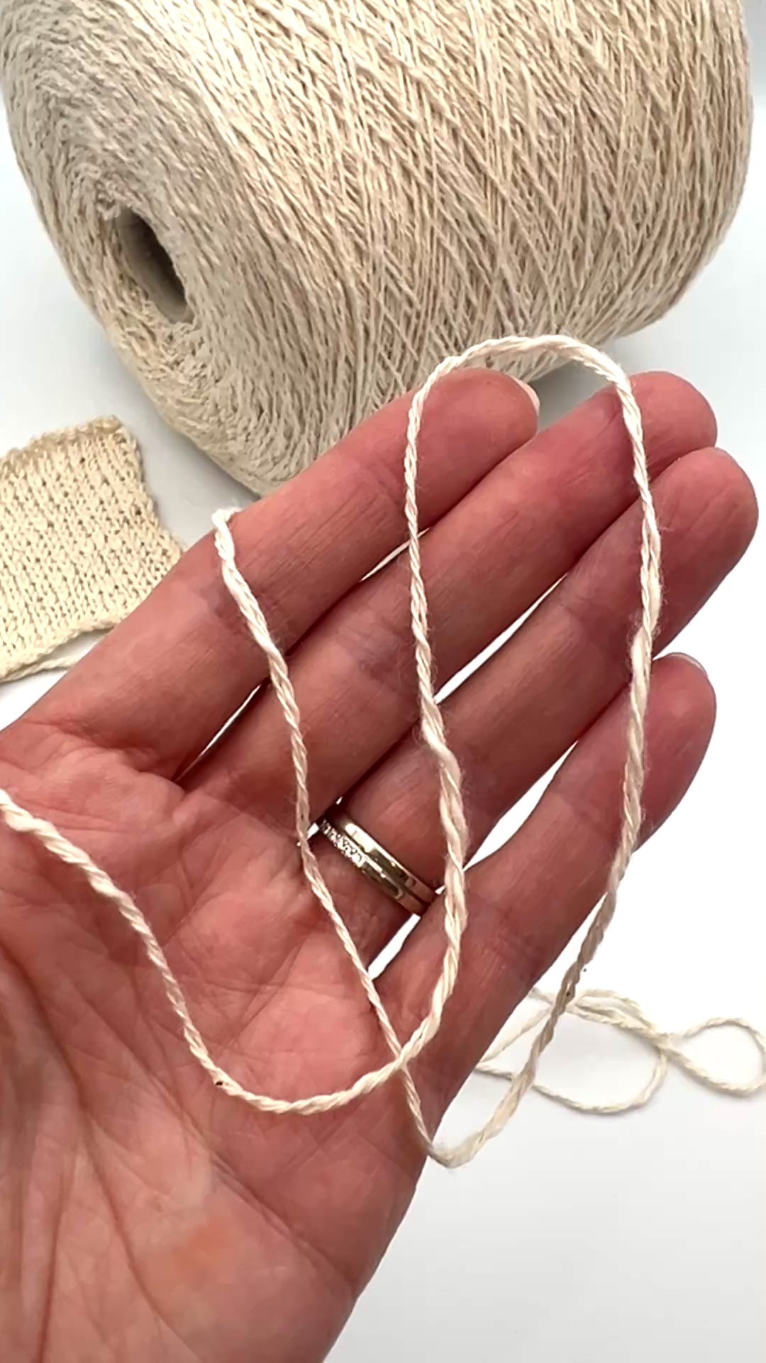 Cone of COTTON FLAME Italian flammé cotton yarn in natural cream color, premium sport weight cotton yarn for sweaters, cardigans, tops, and summer knitwear.