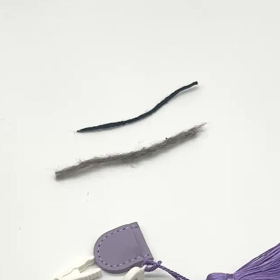 Professional iDOKNiT mini precision thread scissors for crafters. These 42mm spring-style snips feature a decorative tassel and protective cover, designed for sharp, precise trimming of yarn and embroidery floss. Compact and travel-ready accessory curated by iDOKNiT for knitting, crochet, and sewing project bags.