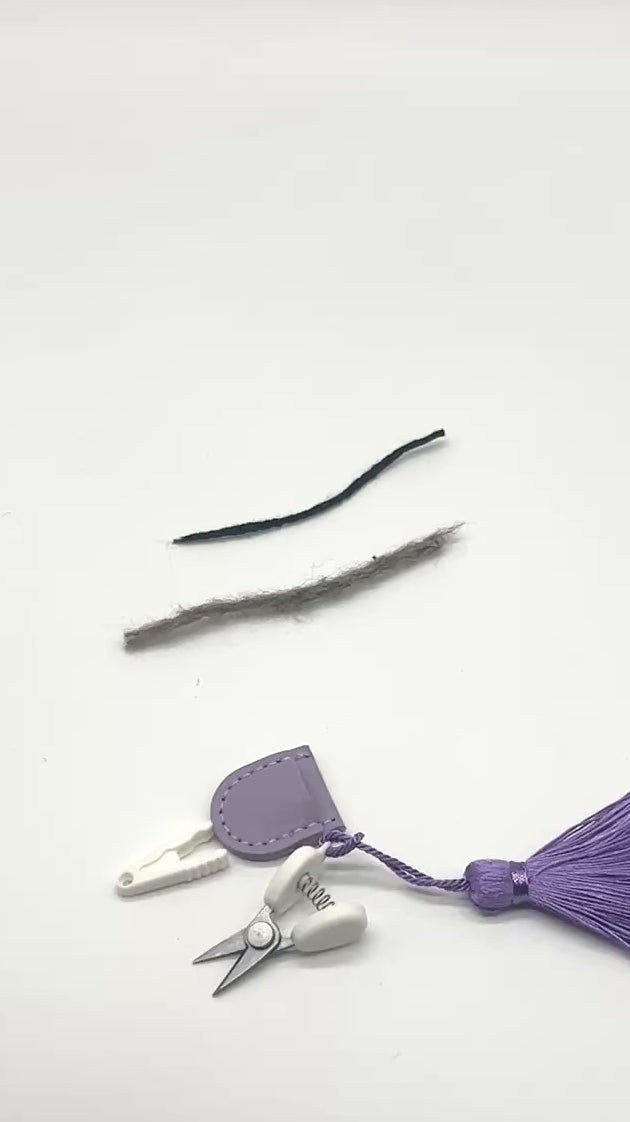 Professional iDOKNiT mini precision thread scissors for crafters. These 42mm spring-style snips feature a decorative tassel and protective cover, designed for sharp, precise trimming of yarn and embroidery floss. Compact and travel-ready accessory curated by iDOKNiT for knitting, crochet, and sewing project bags.