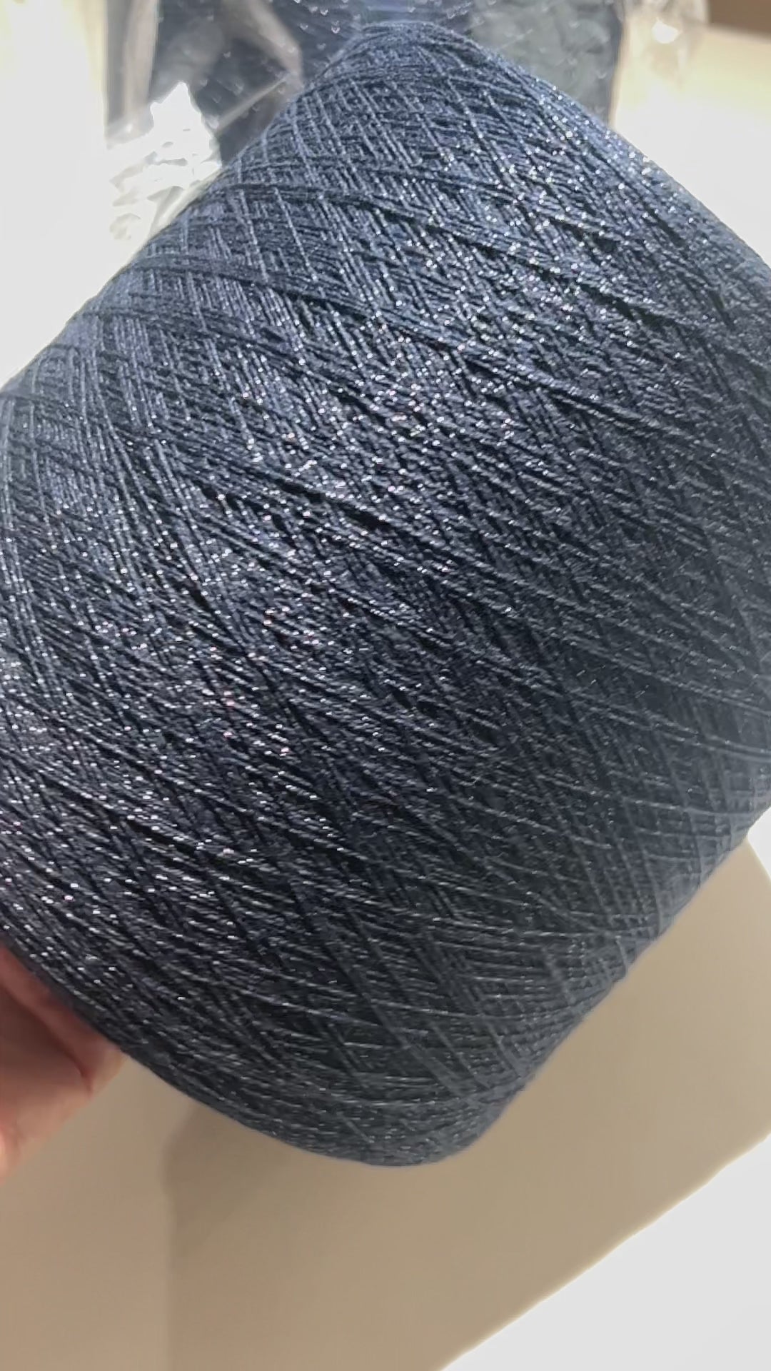 Filati Biagioli Modesto luxury lace yarn shown on a professional cone. This premium Italian blend of cashmere, silk, and cotton features an irregular Lurex thread for subtle shimmer and movement. Sophisticated fashion yarn available at iDOKNiT.com.