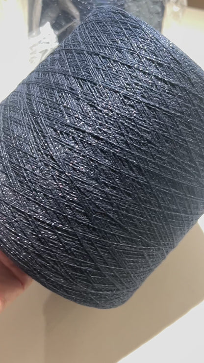 Filati Biagioli Modesto luxury lace yarn shown on a professional cone. This premium Italian blend of cashmere, silk, and cotton features an irregular Lurex thread for subtle shimmer and movement. Sophisticated fashion yarn available at iDOKNiT.com.