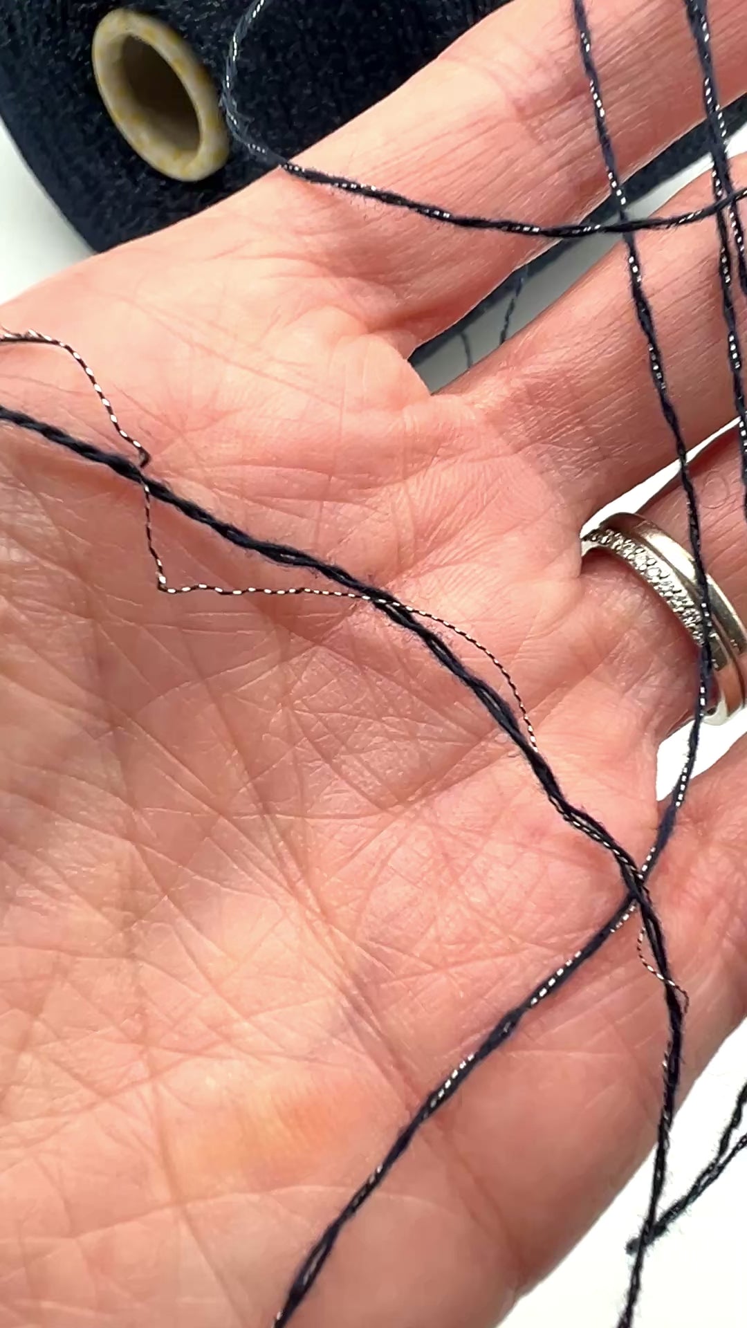 Filati Biagioli Modesto luxury lace yarn shown on a professional cone. This premium Italian blend of cashmere, silk, and cotton features an irregular Lurex thread for subtle shimmer and movement. Sophisticated fashion yarn available at iDOKNiT.com.