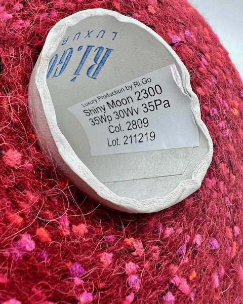 Label on a ball of red yarn with 'Ry Go' branding